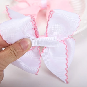 Pink crocheted edge white ribbon bow hair clip with fully wrapped metal duckbill clip