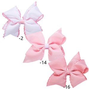 Three sweet baby bow hair clips in pink and white with scalloped embroidery edges