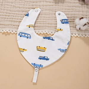 Detail of baby cotton bib featuring blue cartoon car prints with secure snap button closure