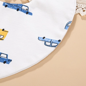 Detailed macro view of baby cotton bib with cartoon cars and delicate lace edges