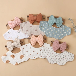 Detail of 6-pack baby bibs and headbands set in floral, bear and rainbow prints