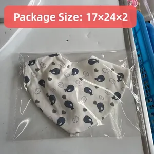 Detail of 17x24x2cm packaged cotton baby bandana bib with whale print and teether