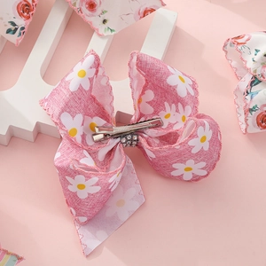 Barrette à cheveux avec grand nœud rose imprimé marguerites et strass brillant