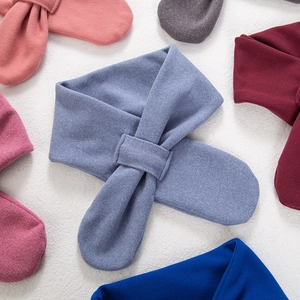 Detail view of colorful cross-slot knit scarves for babies in soft faux cashmere fabric