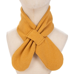 Detailed view of ginger yellow knit scarf with crossover slit and twill texture