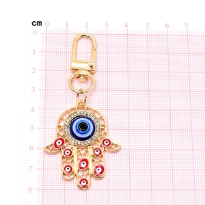 Golden Hamsa hand keychain with colorful Evil Eye pendant and sparkling rhinestones