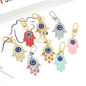 Detail of colorful Hamsa Hand keychains with Turkish Evil Eye charms and rhinestones
