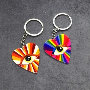 Detailed macro view of heart-shaped evil eye keychains with vibrant rainbow acrylic textures