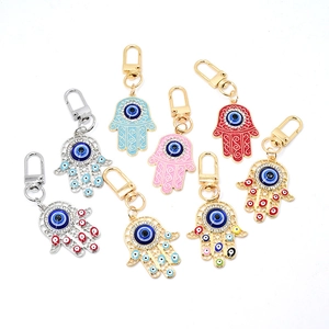 Hamsa Hand and Evil Eye metal keychains with colorful enamel and sparkling rhinestones