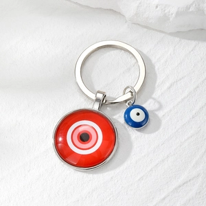Retro evil eye keychain featuring red and blue glass pendants on a silver metal ring