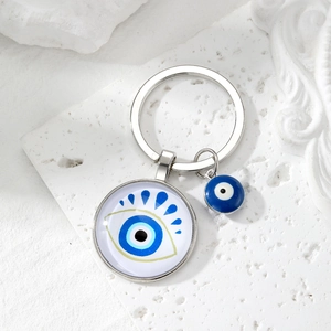 Silver evil eye keychain featuring blue glass pendant and protective charm hanging charm