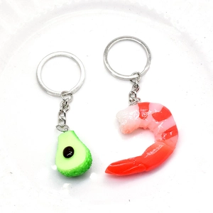 Realistic 3D avocado and shrimp keychain set on a white plate with metal rings