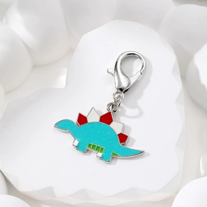Blue glitter enamel stegosaurus pendant keychain with silver lobster clasp on white stand