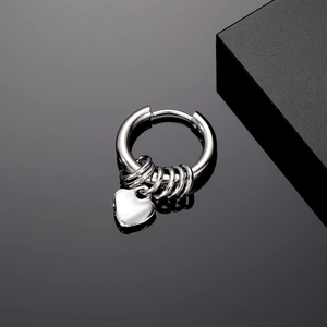 Vintage punk stainless steel earring with heart pendant and multiple rings on black background