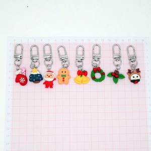 Christmas resin keychain set with cartoon Santa Claus and reindeer on pink grid board