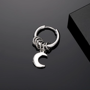 Detailed view of punk moon pendant earring in silver stainless steel on black background