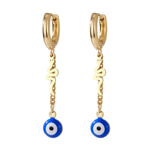 Detail of gold snake earrings with blue evil eye enamel charm on white background