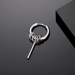 Close-up of a silver minimalist punk earring with five small rings and a long polished bar