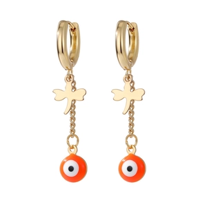 Detail of golden dragonfly earrings with orange evil eye charm and cross chain pendants