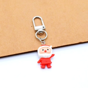 Detail view of cartoon Santa Claus resin keychain with silver metal lobster clasp