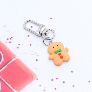 Cartoon gingerbread man Christmas keychain with green bow and silver lobster clasp
