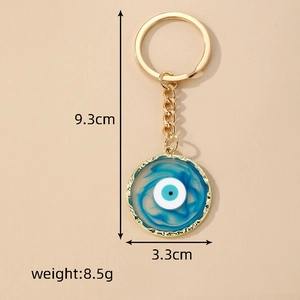 Evil eye keychain with blue swirl pendant and gold metal trim, dimensions 9.3x3.3cm