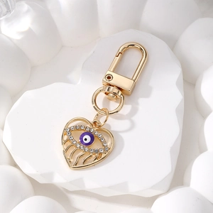 Golden heart-shaped Evil Eye keychain with purple enamel and sparkling crystal rhinestones
