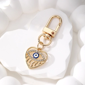 Detailed macro of golden heart devil eye keychain with sparkling rhinestones decoration