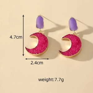 Detailed view of crescent moon earrings with purple resin and gold trim, 4.7cm in height