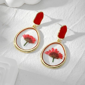 Handmade gold teardrop earrings with real red dried flowers in clear resin pendants