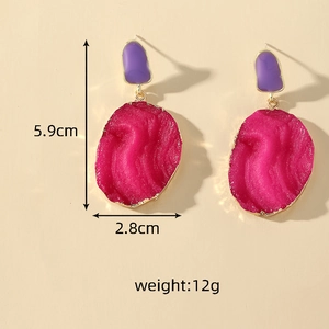 Detail shot of irregular resin drop earrings showing size dimensions and gold-plated edges