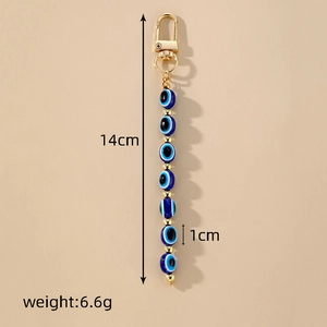Detail showing length and size dimensions of the blue evil eye beaded keychain