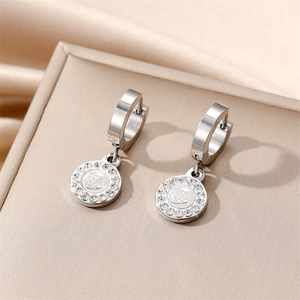 Polished stainless steel hoop earrings with saint medal pendant and sparkling rhinestones