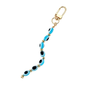 Vintage evil eye keychain with blue resin beads and golden lobster clasp on white background