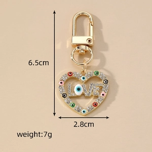 Golden LOVE heart keychain with crystal evil eye charms and a blue eye bead pendant