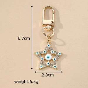 Evil eye star keychain in gold with blue stones and crystals, size 6.7x2.8cm