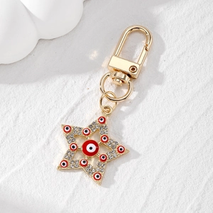 Ethnic gold star keychain with evil eye patterns and sparkling crystals in 45-degree view