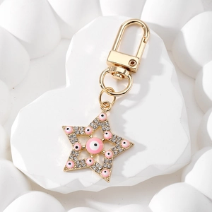 Ethnic style rose gold star keychain with pink evil eye enamel and white rhinestones