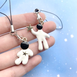 Cute astronaut charm set with gold stars and black and white enamel for phone and keys