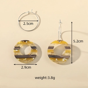 Detail view of retro earrings with wood texture, gold foil, and 5.2cm total length