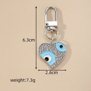 Detail view of evil eye heart keychain with dimensions 6.3cm height and 2.6cm width
