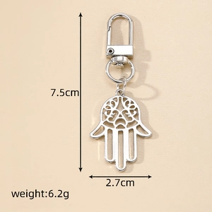 Detail of silver Hamsa Hand keychain with hollow patterns, 7.5cm long and 6.2g weight