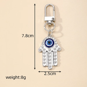 Silver Hamsa Hand keychain with blue Evil Eye charm, measuring 7.8cm in height and 2.5cm wide