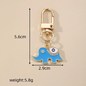Macro detail of elephant keychain with blue evil eye design and gold plating finish