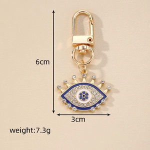 Detailed view of evil eye heart keychain with blue crystals and measurement specs