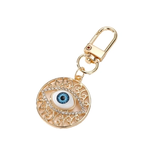Vintage evil eye keychain with gold hollow patterns and sparkling rhinestones