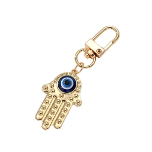 Golden Hamsa Hand keychain with Evil Eye resin inlay and secure lobster clasp on white background
