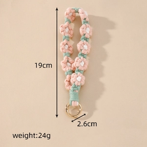 Macro detail of handmade crochet floral wristlet with 19cm length and golden metal ring