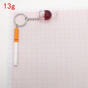 Creative cigarette and red wine glass keychain charms weighing 13g on scale grid