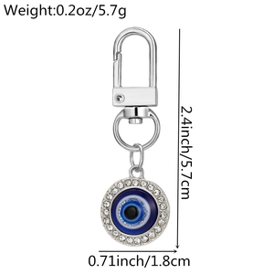 Detail showing the dimensions and weight of the silver Evil Eye keychain with blue rhinestones